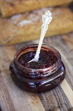 Close up of spoon in jar of jam