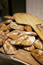 Bread peel on pile of homemade loaves
