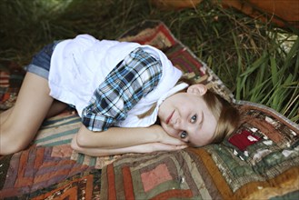 Girl laying on blanket in camping tent