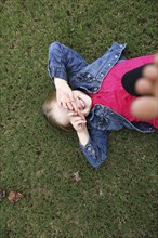 High angle view of girl laying in grass