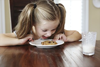 Girl shouting at cookie on table