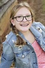 Smiling Caucasian girl with braces and eyeglasses