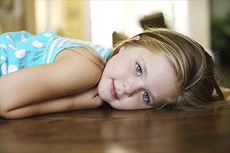 Close up of smiling girl laying on floor