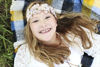 Close up of smiling Caucasian girl with flower crown and braces