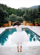 Bride diving into swimming pool