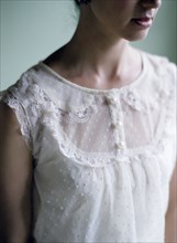 Close up of woman wearing lace blouse