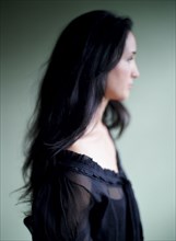 Close up of woman with long hair and lace blouse
