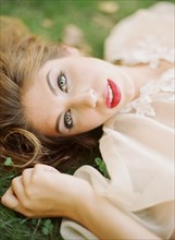 Close up of woman laying in grass
