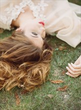 Close up of woman laying in grass