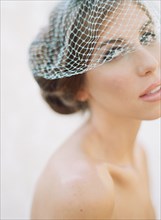 Close up of bride wearing birdcage veil