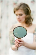 Bride admiring herself in mirror