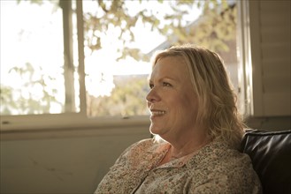 Close up of older woman smiling near window