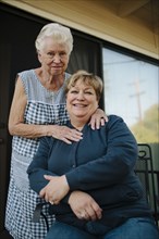 Older woman standing with daughter
