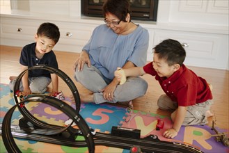 Asian grandmother playing with grandsons