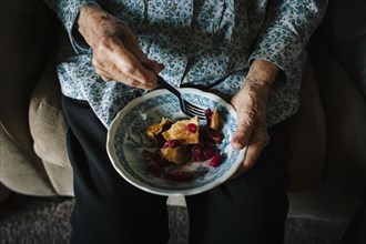 Close up of older mixed race woman eating