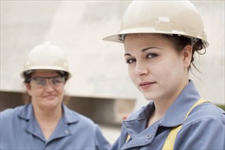 Workers wearing hard-hats and uniforms at work