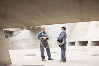 Workers talking at construction site