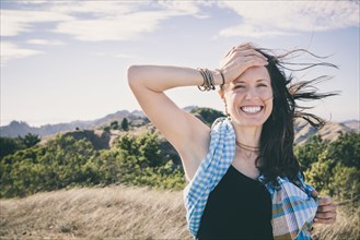 Caucasian woman laughing in rural field