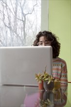 Caucasian businesswoman using laptop at desk