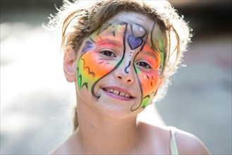Close up of smiling Caucasian girl with face paint