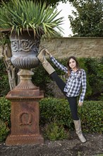 Caucasian teenage girl stretching leg in backyard
