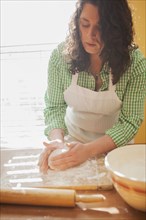Baker shaping dough on counter