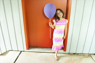 Caucasian girl holding balloon