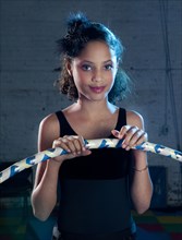 Mixed race girl holding plastic hoop
