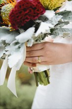Close up of bride wearing wedding rings