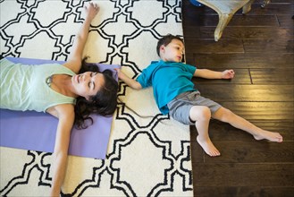 Mother and son laying on floor