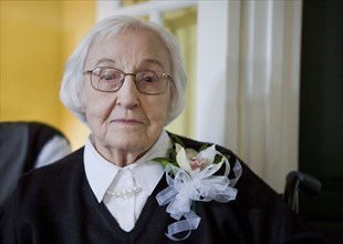 Older Caucasian woman wearing flower corsage