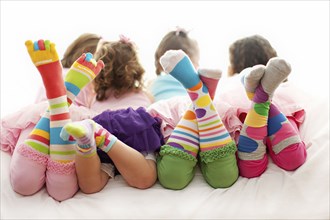 Rear view of girls wearing colorful socks