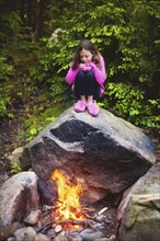 Caucasian girl admiring campfire