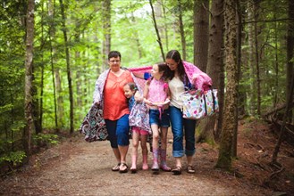 Three generations of Caucasian women walking in forest