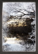 Frosty window and view of rural lake