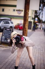 Caucasian woman photographing outdoors