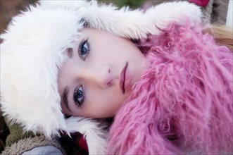 Caucasian teenage girl wearing fuzzy hat