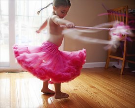 Caucasian girl twirling in skirt