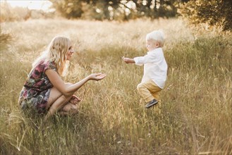 Mother and son playing in field