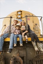 Family sitting on vintage train