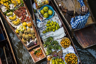High angle view of merchant selling fruit in canoe