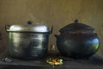 Close up of iron and steel pots on kitchen counter