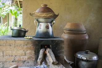 Pots cooking food over wood stove in outdoor kitchen