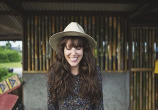Smiling Caucasian woman wearing sun hat outdoors
