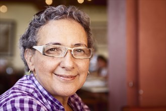 Smiling Hispanic woman wearing eyeglasses