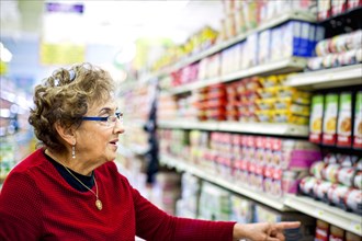 Senior Hispanic woman shopping in grocery store