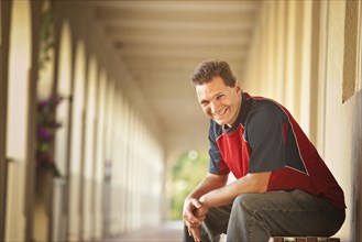 Smiling Caucasian man sitting outdoors