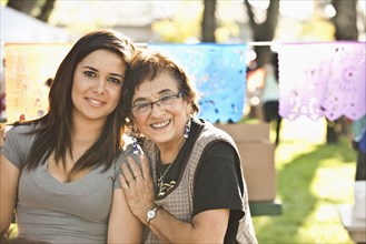 Smiling Hispanic grandmother and granddaughter