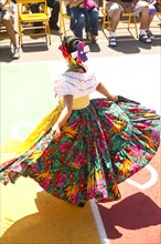 Hispanic girl in costume dancing