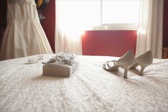 Wedding shoes and bible on bed